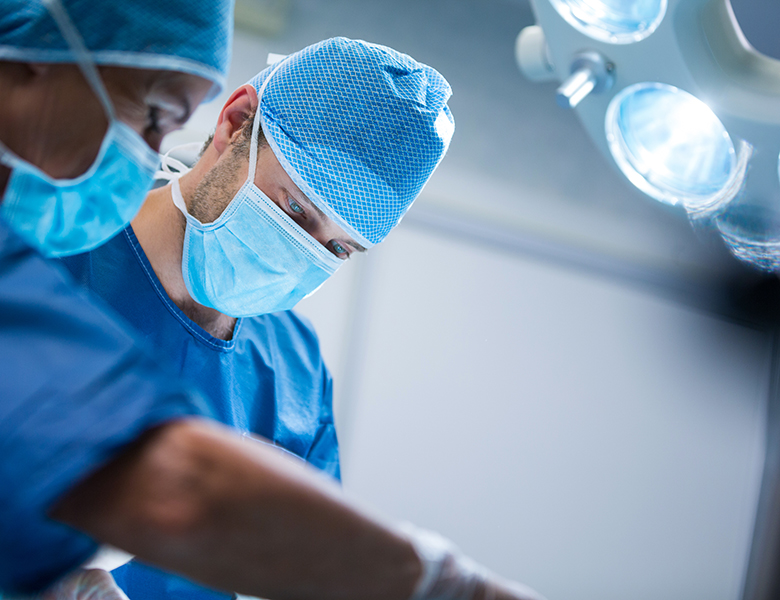 Surgeons performing operation in operation room